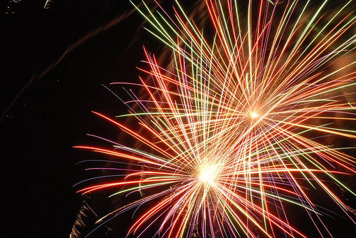A close-up of an exploding firework against a black night sky