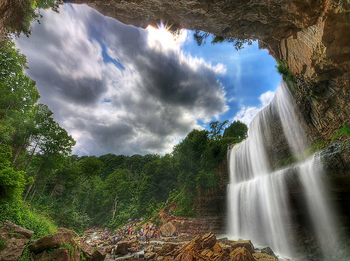 A photograph of a waterfall taken in bright sunlight.