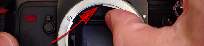 The pentaprism is located above the reflex mirror in a DSLR camera; immediately in front of the viewfinder.